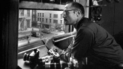 W. Eugene Smith looking out over Sixth Avenue. The window was “his proscenium arch.”