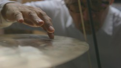 Sakamoto with bow and cymbal.