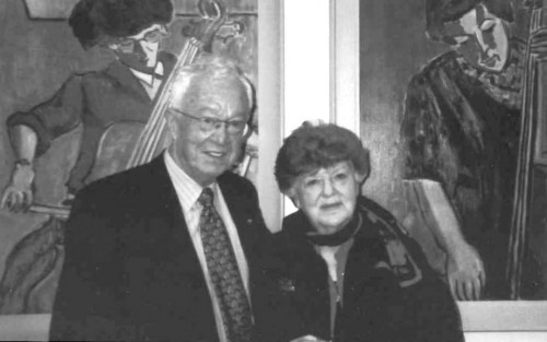 In October 2000, the Faculty of Music celebrated the permanent installation of a collection of musical portraits by Canadian artist and distinguished German scholar Professor Barker Fairley (1887-1986), thanks to a donation from the Fairley family. The fourteen paintings date from 1957 to 1964 and belong to the U of T Art Collection. Ezra Schabas, Fairley’s son-in-law, is pictured here at the opening with Ruth Budd whose portrait hangs beside her.