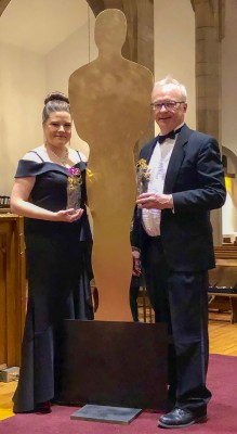 Michele Jacot and Roy Greaves with “Oscar” at their last concert when the theme was “A Night at the Oscars.” Photo by Paul Bryan