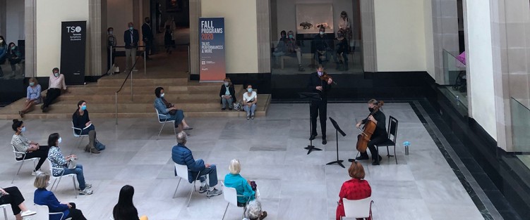Jonathan Crow (violin) and Joseph Johnson (cello) perform for a physically-distanced audience at the Art Gallery of Ontario. Image c/o TSO.
