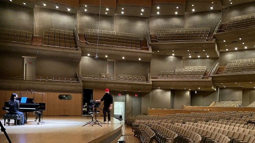 Pianist Lisa Tahara and cinematographer Adam W. Crosby, filming in Roy Thomson Hall for the upcoming documentary. Photo by Lisa Horvat