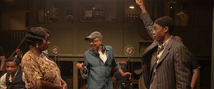 L-R: Dusan Brown (far left), Viola Davis, George C. Wolfe, and Chadwick Boseman, on the set of Ma Rainey’s Black Bottom (2020). Photo credit: David Lee/Netflix.