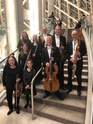 Bach among friends: gathered on the Grand Staircase in the west lobby of Roy Thomson Hall. Back row (left to right): Sarah Jeffrey (oboe), Leonie Wall (flute), Andrew McCandless (trumpet), Jonathan Crow (violin), Michael Sweeney (bassoon) Second row (left to right): Kelly Zimba Lukić (flute), Joseph Johnson (cello) Front row (left to right): Amalia Joanou-Canzoneri (violin) and Chelsea Gu.