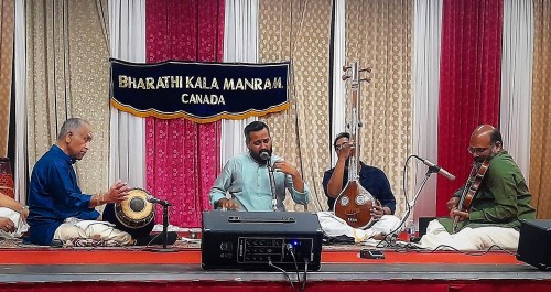 L to R: Trichy Sankaran (mridangam) in concert with vocalist Sandeep Narayanan, an unknown tambura player and violinist V.V.S. Murari at the Canada Kanthaswamy Temple, October 8, 2022. (Note:the tambura player in Carnatic music is often a student or community member. They are usually not announced in advance and are uncredited – as in the case of this concert.)