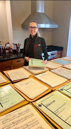 Ingrid Martin has learned to read titles and instrument names – in German or English – upside down as we load music into envelopes. Photo by Gary Corrin.