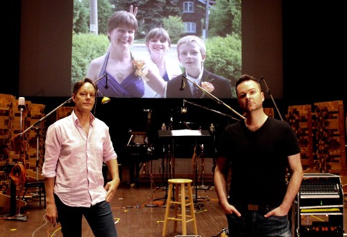 "My wife Zoe took this photo when Jake Heggie (L) & I got together at Skywalker Sound (Marin County, CA) to record his powerful cycle - Songs for Murdered Sisters - in the thick of the fall 2020 pandemic shutdowns. My sister, Nathalie Warmerdam, is pictured with her two children on the big screen. I wanted the image of her smile looking down on me as I recorded such a personal tribute to her." - Joshua Hopkins. Photo by Zoe Tarshis.