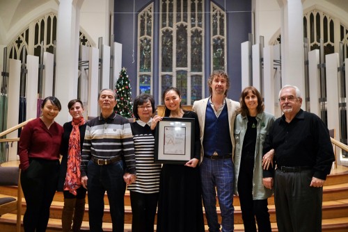 Elaine Choi (centre) receiving the Ontario Arts Council’s 2023 Leslie Bell Prize for Choral Conducting . At left are her parents, David and May; at right, her husband, Noel.