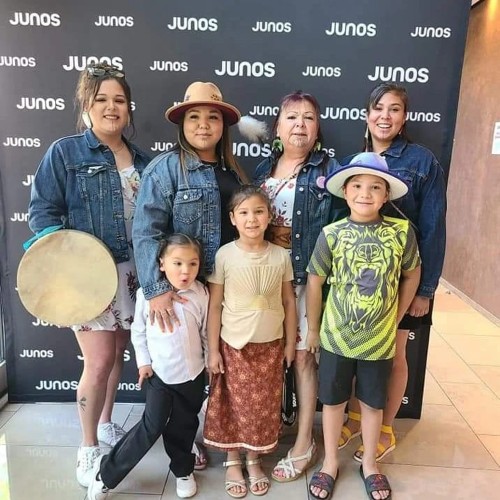Manitou Mkwa Singers, (Spirit Bear Singers) are from the Mississaugas of the Credit: a mother, six daughters and a son, pictured here as 2022 Juno award nominees for their album "Manitou Mkwa Singers Volume 2". It was the first year that an award was made for Traditional Indigenous Artist of the Year. A family hand drum group that sings pow-wow and round dance songs, their music is meant to uplift the spirits of people and bring good positive energy to those in need. Photo via Facebook.