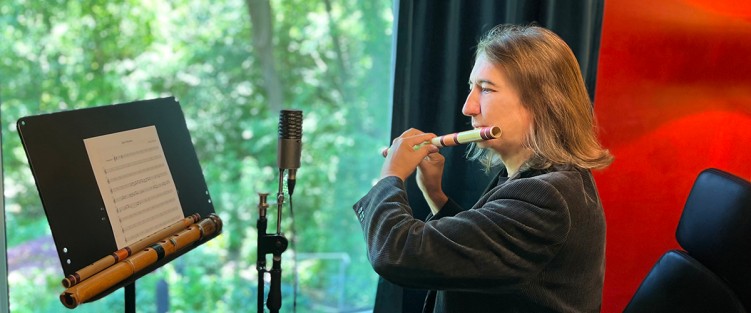 Ron Korb in his studio. The flute he is playing is the Bansuri. On the stand: another bansuri and a shakuhachi. Photo by Jade Ye