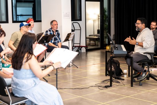 Music director Ryan deSouza (right) and members of the Octet cast in rehearsal. Photo by Dahlia Katz.